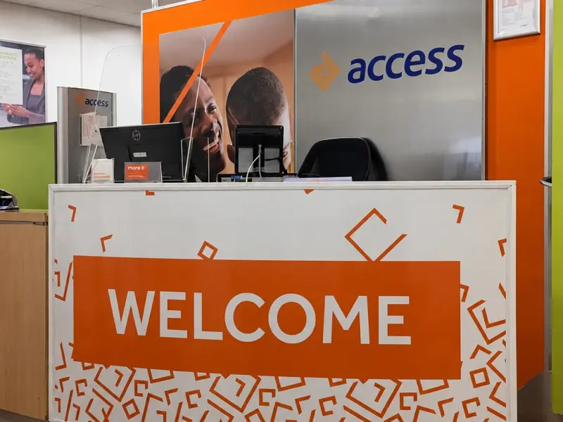 Branded Access Bank reception desk with printed Welcome panel and backlit logo