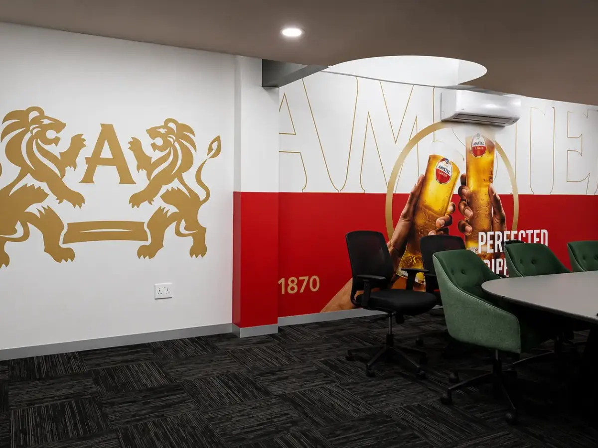 Amstel wall graphics in a boardroom featuring the brand crest and 1870 heritage date