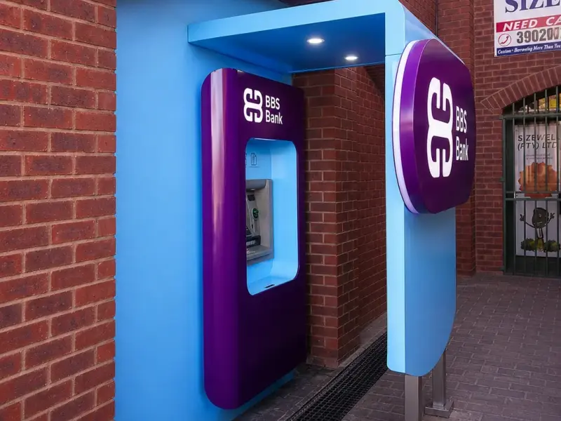 Illuminated BBS Bank ATM surround set under a brick archway