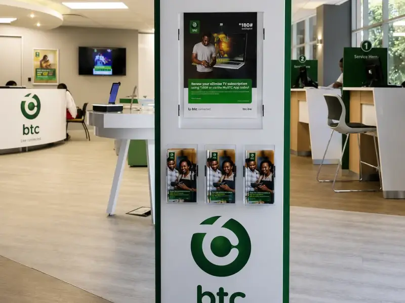 Freestanding BTC digital totem and brochure display in a store