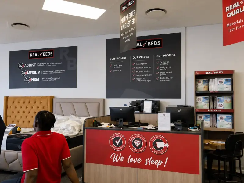 Hanging ceiling mobiles and branded counter graphics in a bed retail store