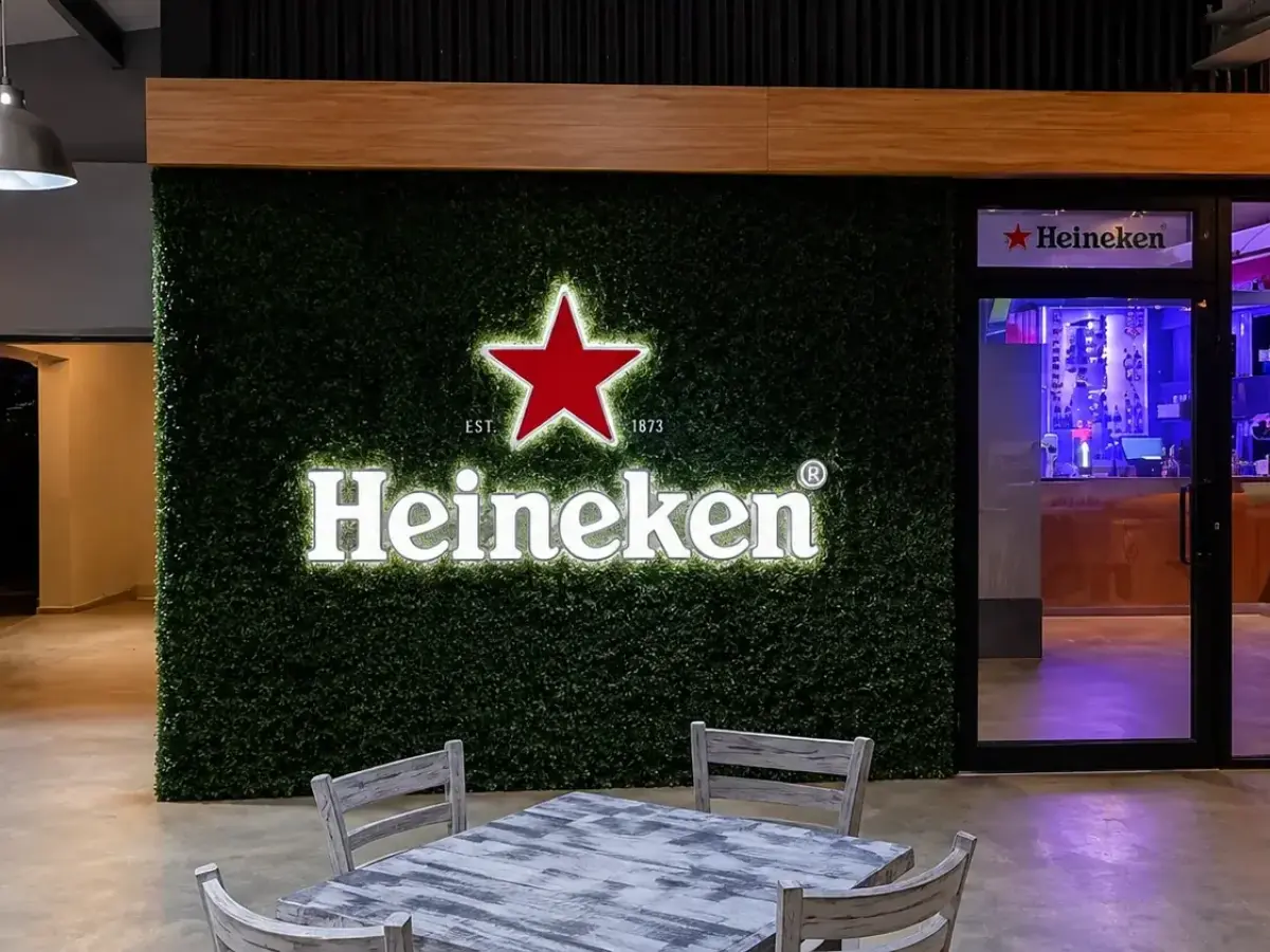 Neon Flex illuminated letter Heineken on custom grass wall