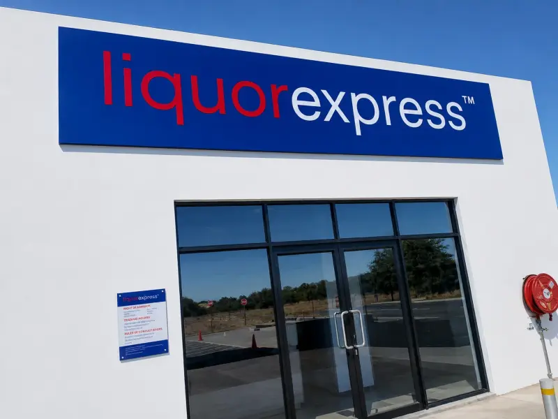 Illuminated Liquor Express fascia sign above a shopfront