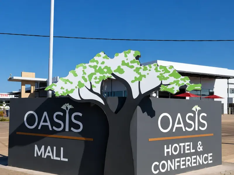 Oasis Mall Hotel and Conference monument sign with a cut-out tree graphic