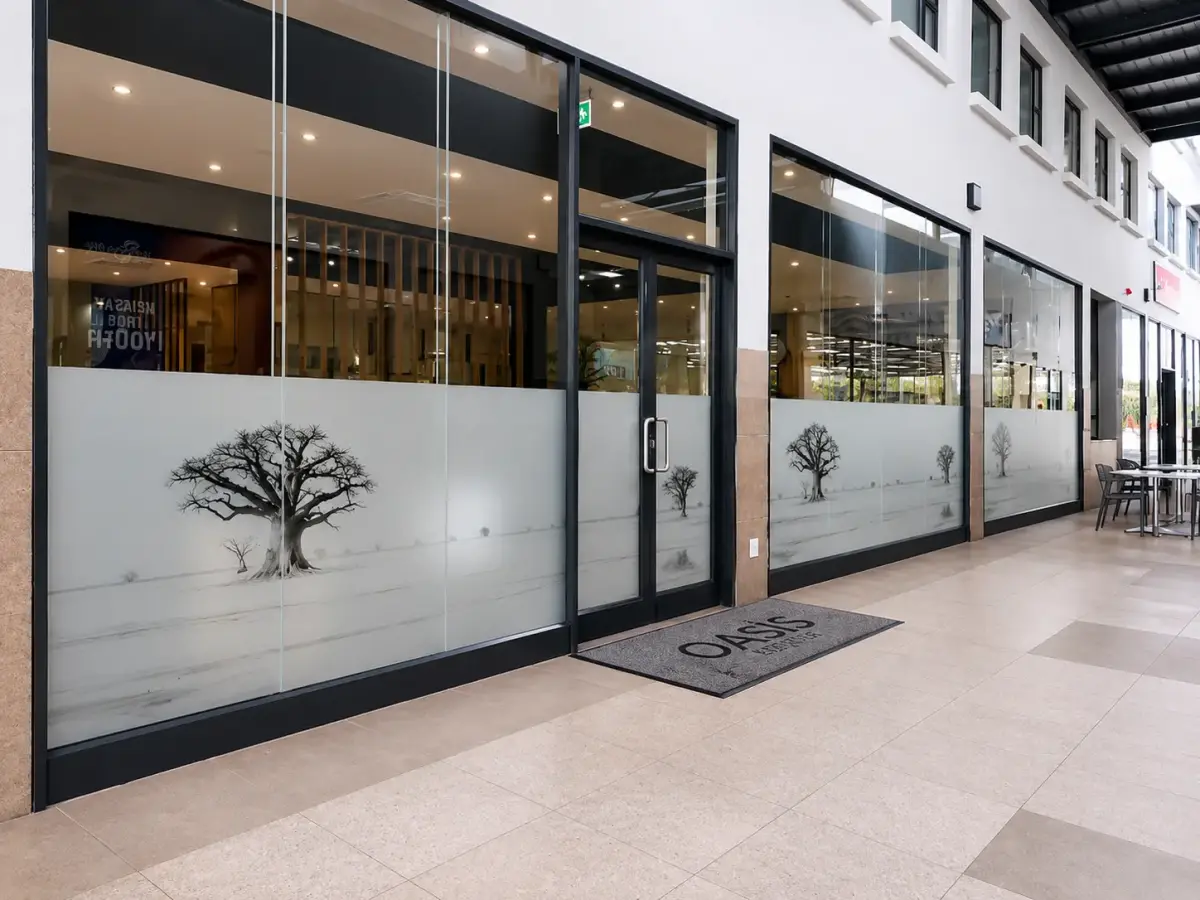 Printed window graphics with baobab tree illustrations at Oasis Mall