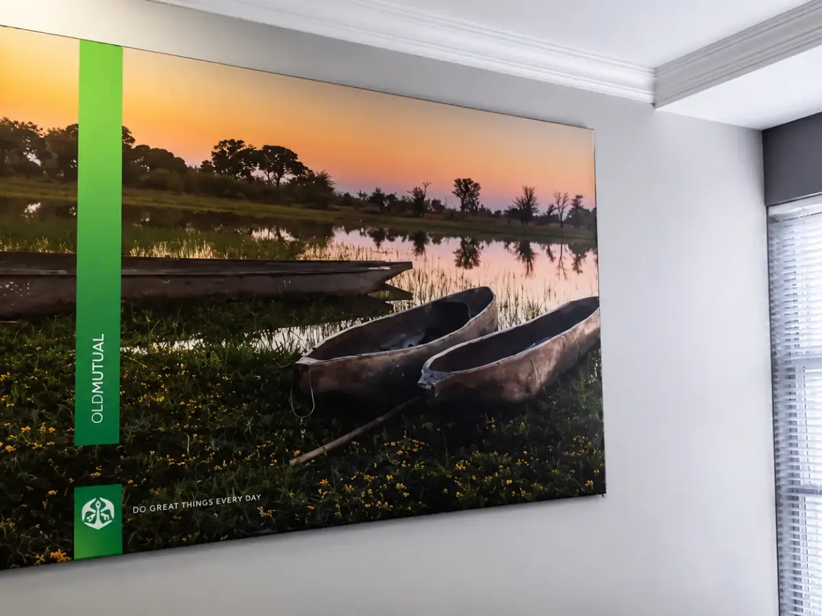 Framed Old Mutual wall print of mokoro canoes with the strapline Do great things every day