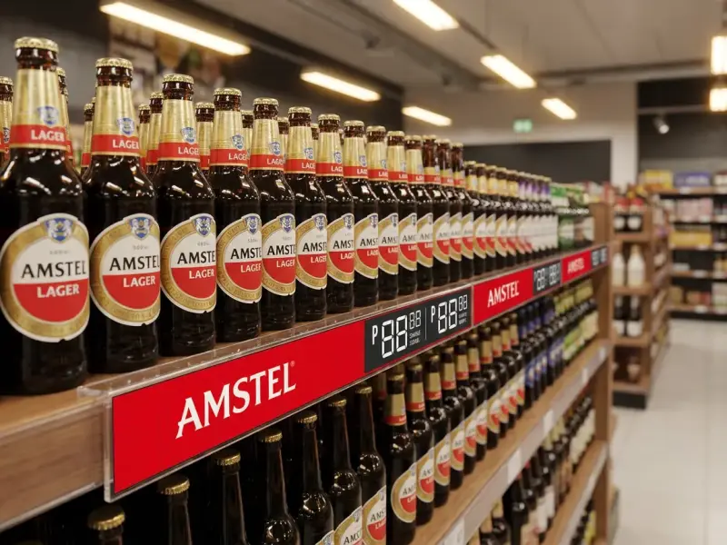 Amstel shelf strip and price rail on a liquor store shelf