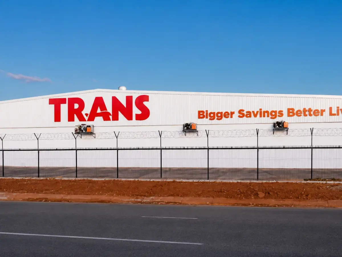Trans supermarket roof sign reading Bigger Savings Better Living
