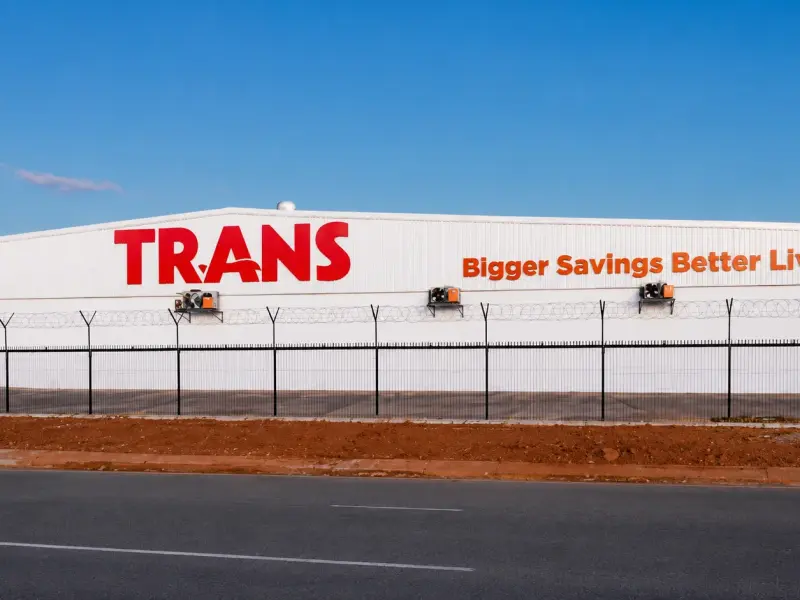 Trans supermarket roof sign reading Bigger Savings Better Living