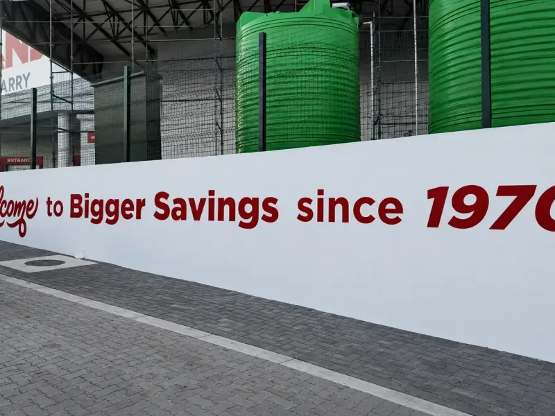 Painted wall graphic reading Welcome to Bigger Savings since 1970
