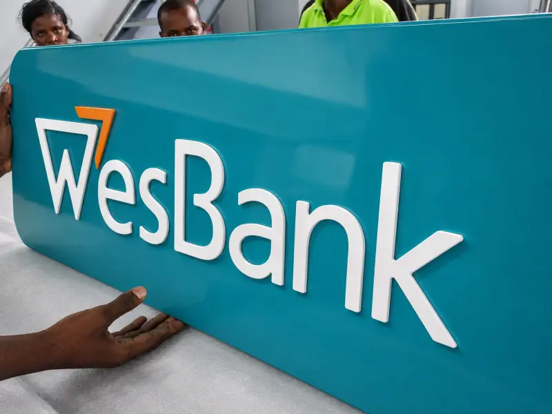 Fabricated WesBank sign panel being installed
