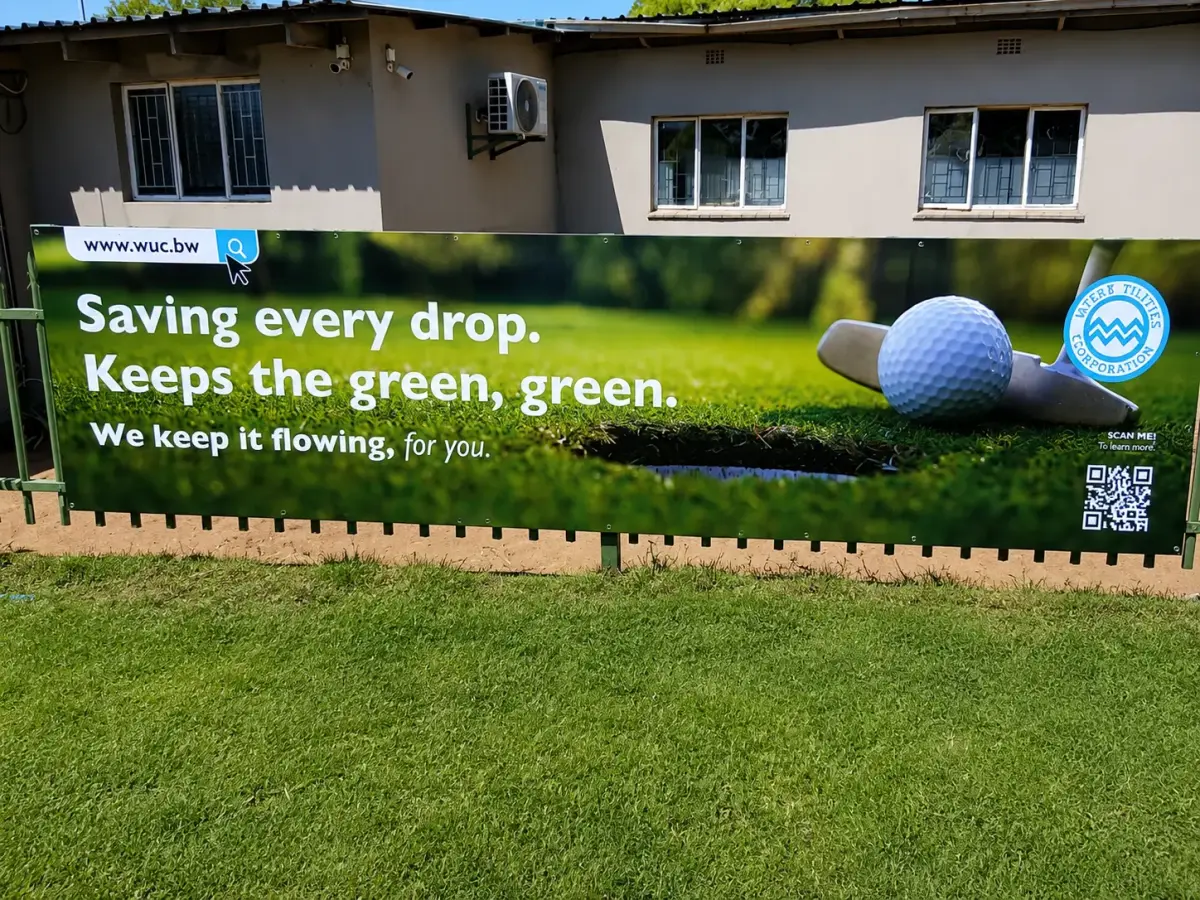 Water Utilities Corporation printed banner on a golf course reading Saving every drop